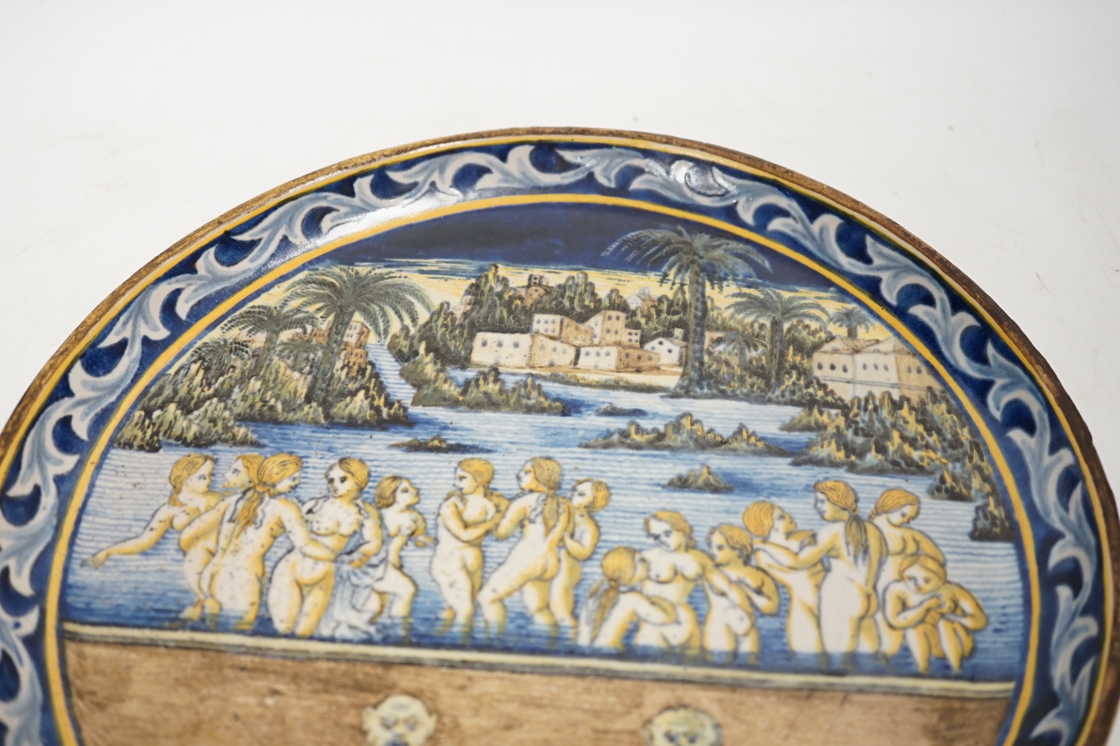 An 18th / 19th century Castelli maiolica plate, decorated with nude females bathing, 28.5cm diameter. Condition - fair to good
